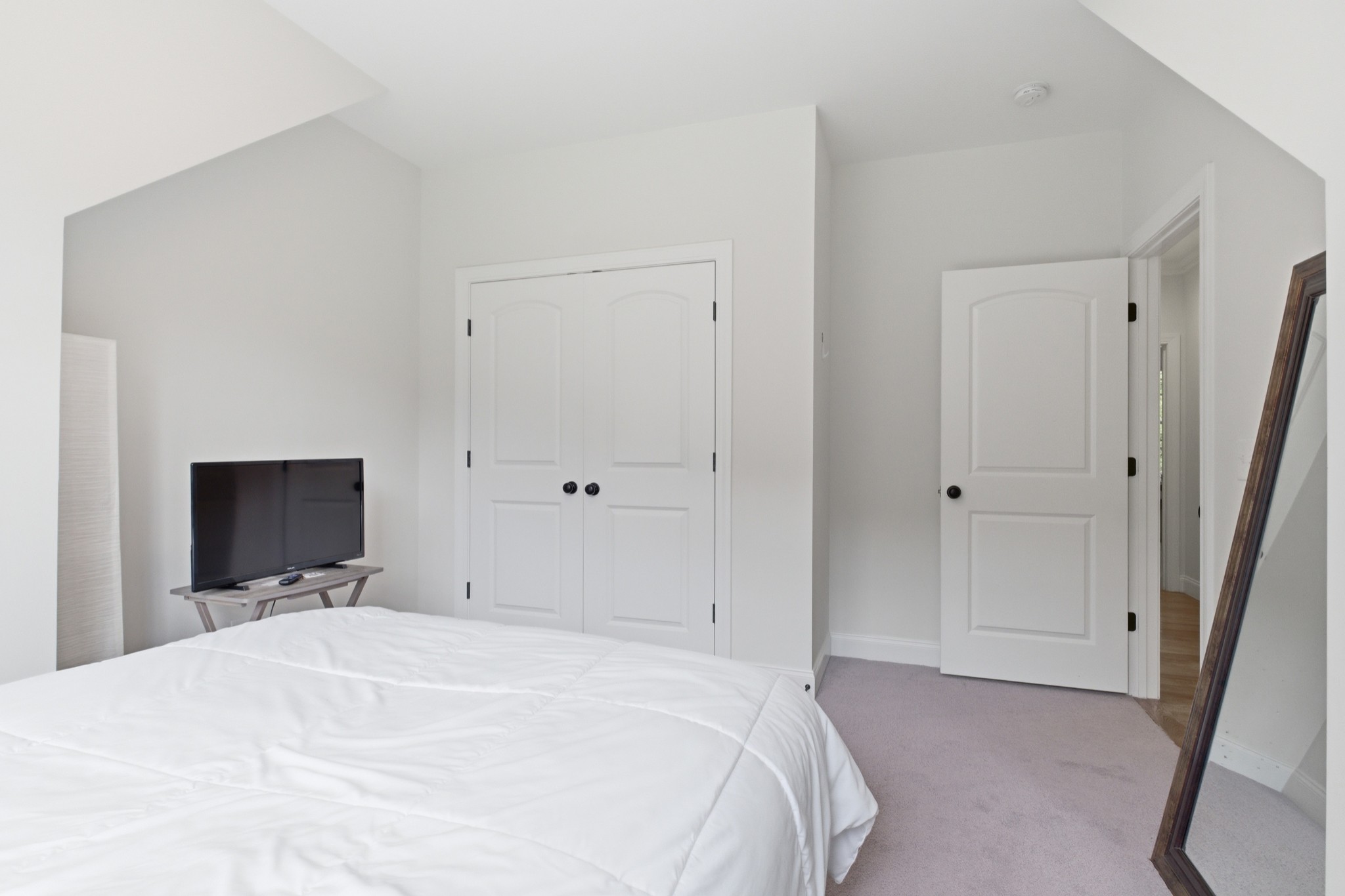 7075 Pinewood Road Nunnelly, TN 37137 - Photo 29 of 49 a bedroom with a bed and a flat tv screen
