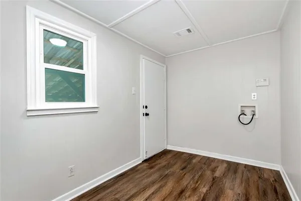 a view of a room with wooden floor and windows