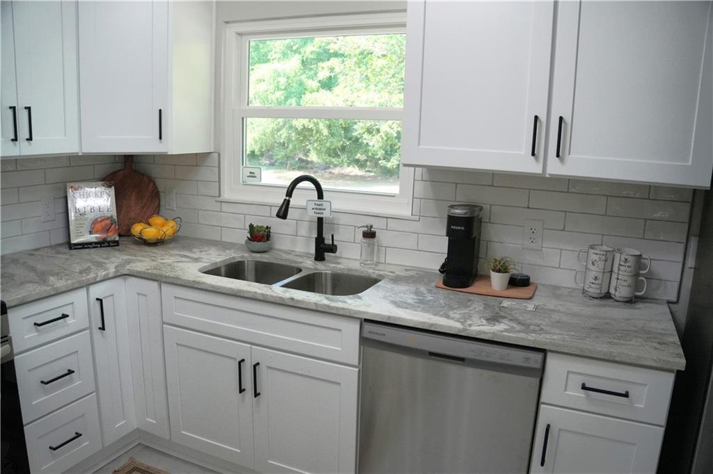 145 Beaverdam Road Winterville, GA 30683 - Photo 16 of 53 a kitchen with sink cabinets and window