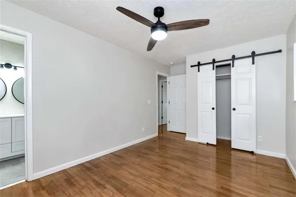 a view of empty room with wooden floor