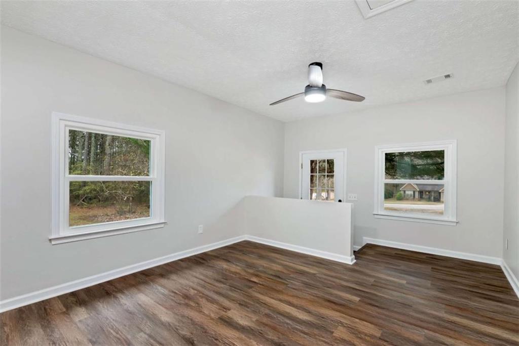 145 Beaverdam Road Winterville, GA 30683 - Photo 23 of 39 a view of an empty room with wooden floor and a window