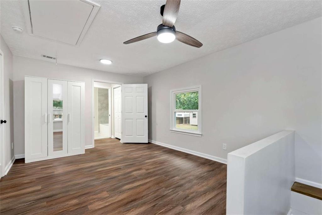 145 Beaverdam Road Winterville, GA 30683 - Photo 24 of 39 a view of an empty room with window and wooden floor
