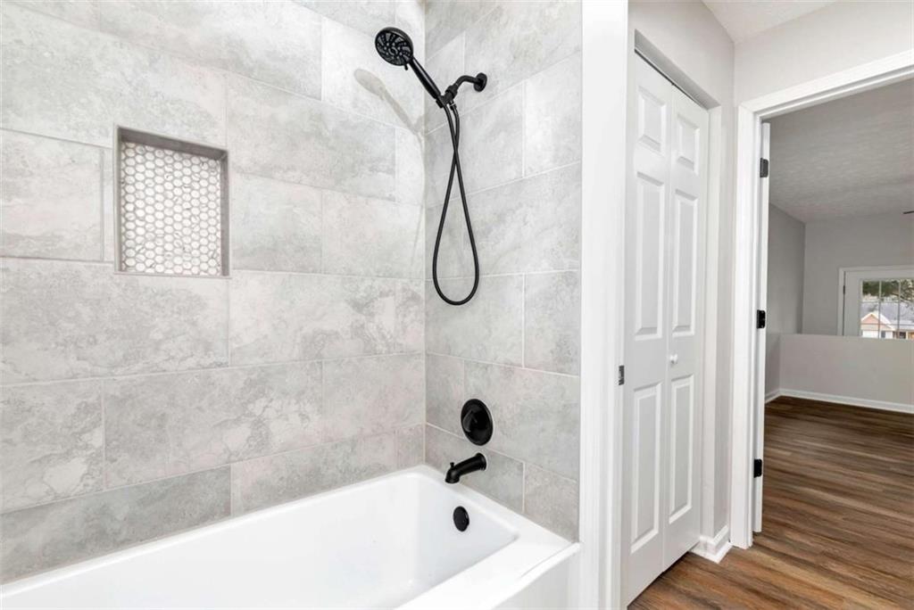 145 Beaverdam Road Winterville, GA 30683 - Photo 26 of 39 a bathroom with a bath tub with a shower
