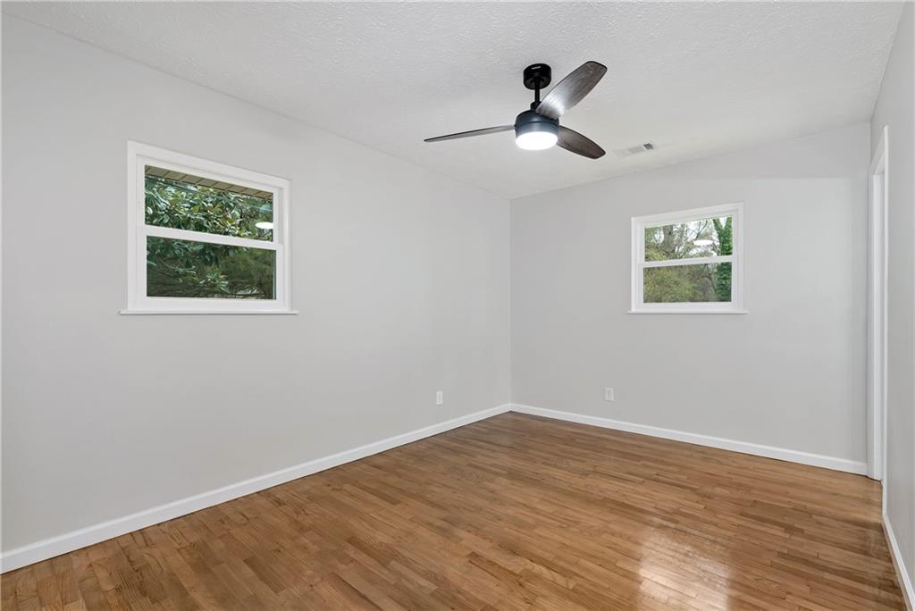 145 Beaverdam Road Winterville, GA 30683 - Photo 28 of 53 a view of empty room with wooden floor and fan