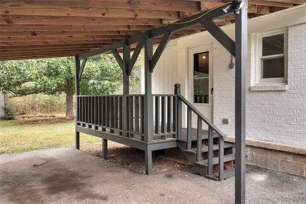 a view of outdoor space with wooden floor and iron fence