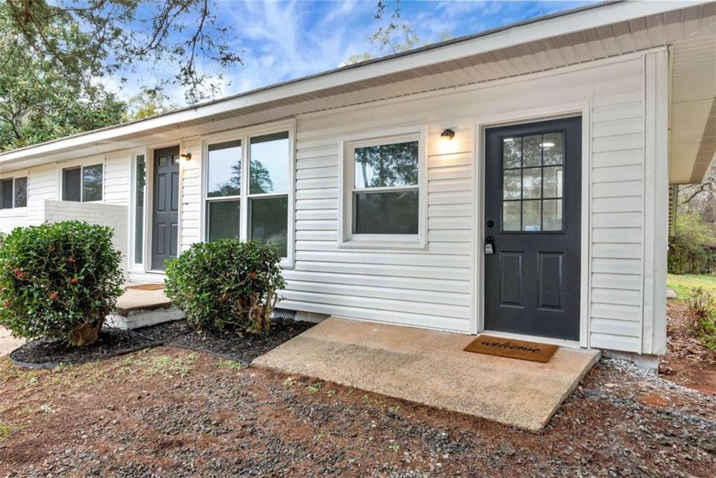 145 Beaverdam Road Winterville, GA 30683 - Photo 3 of 39 a front view of a house with garden