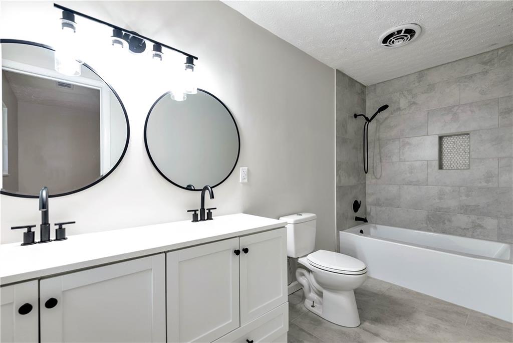 145 Beaverdam Road Winterville, GA 30683 - Photo 32 of 53 a bathroom with a toilet sink and mirror