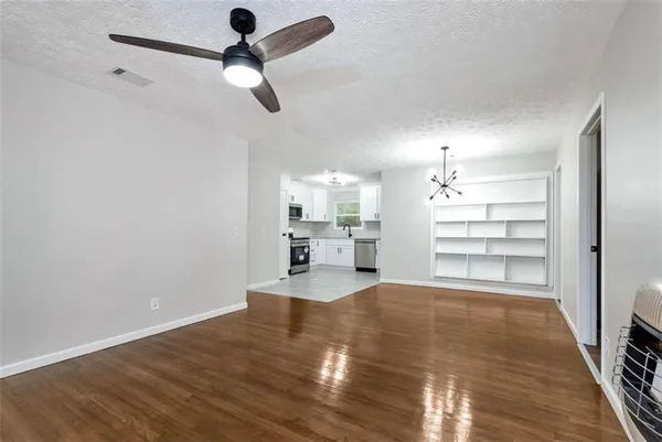 a room with natural light and hardwood floor