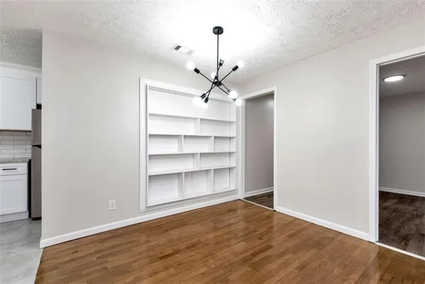 a view of a room with a cabinet and a ceiling fan