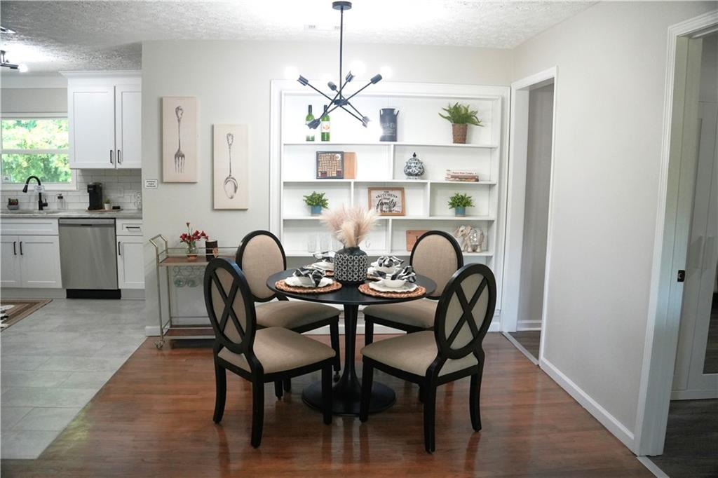 145 Beaverdam Road Winterville, GA 30683 - Photo 10 of 53 a view of a dining room with furniture window and wooden floor