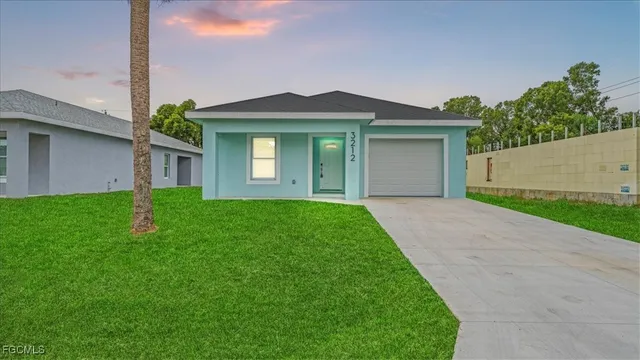 a view of a front of a house with a yard