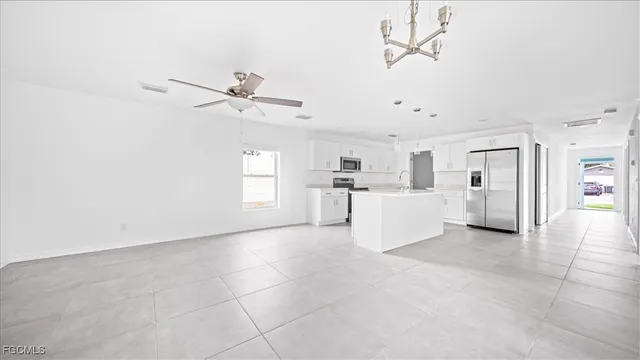 a view of a kitchen with furniture and a ceiling fan