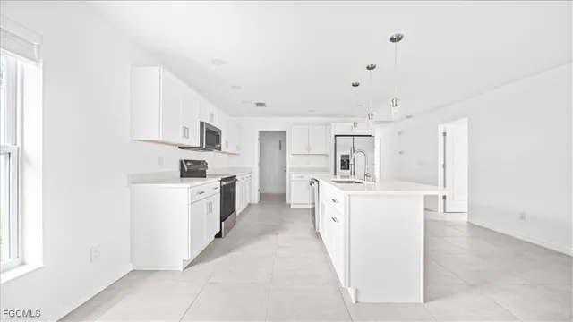 a kitchen with cabinets and white appliances