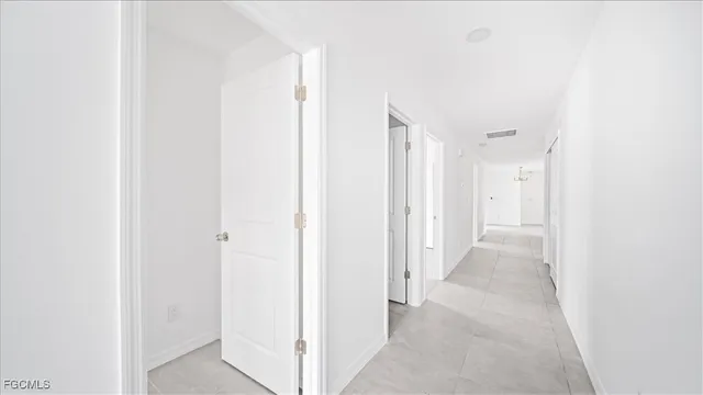 a view of a hallway with wooden shelves