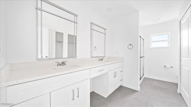a bathroom with a double vanity sink and mirror