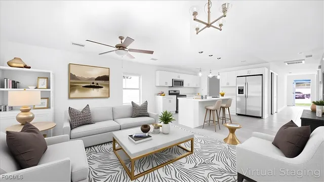 a living room with furniture kitchen view and a chandelier