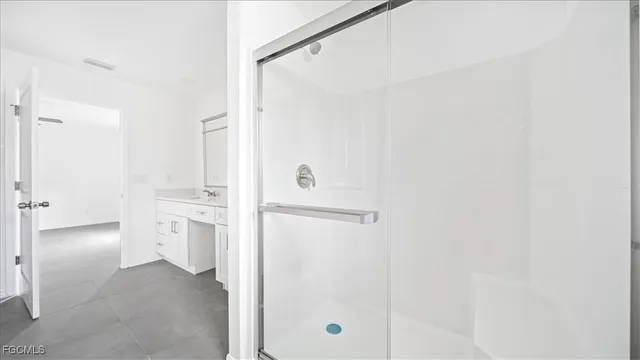 a bathroom with a shower sink and mirror