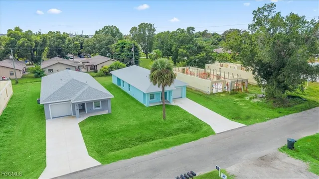 a view of a garden with a house in the background