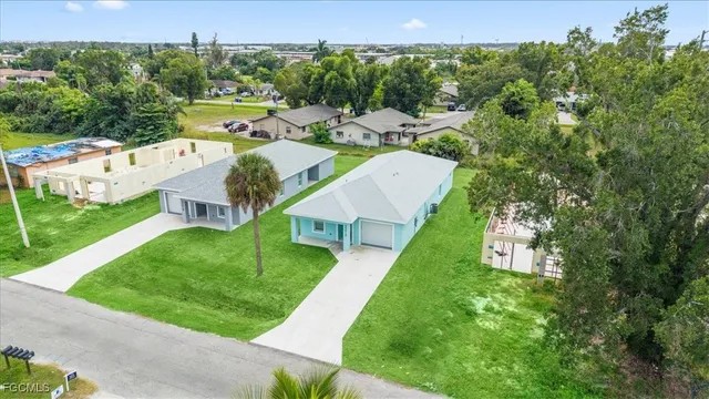 an aerial view of residential houses with outdoor space and street view