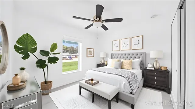 a bedroom with a bed potted plant with the wooden floor
