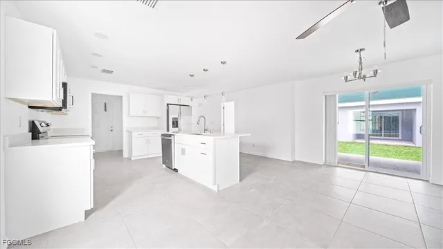 a view of a kitchen with furniture and natural light