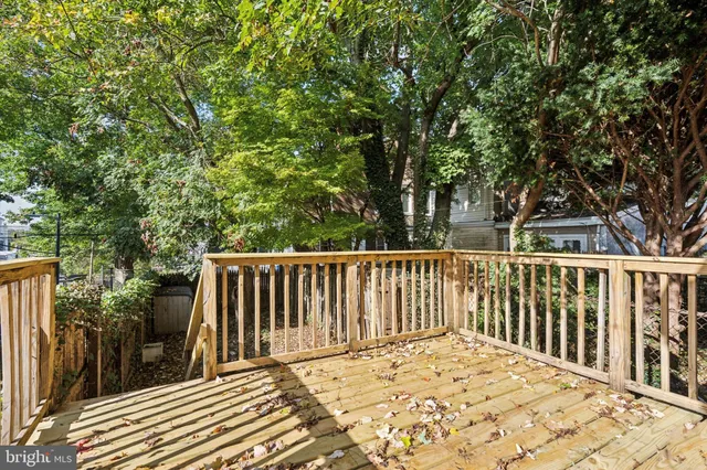 a view of balcony with wooden floor and fence
