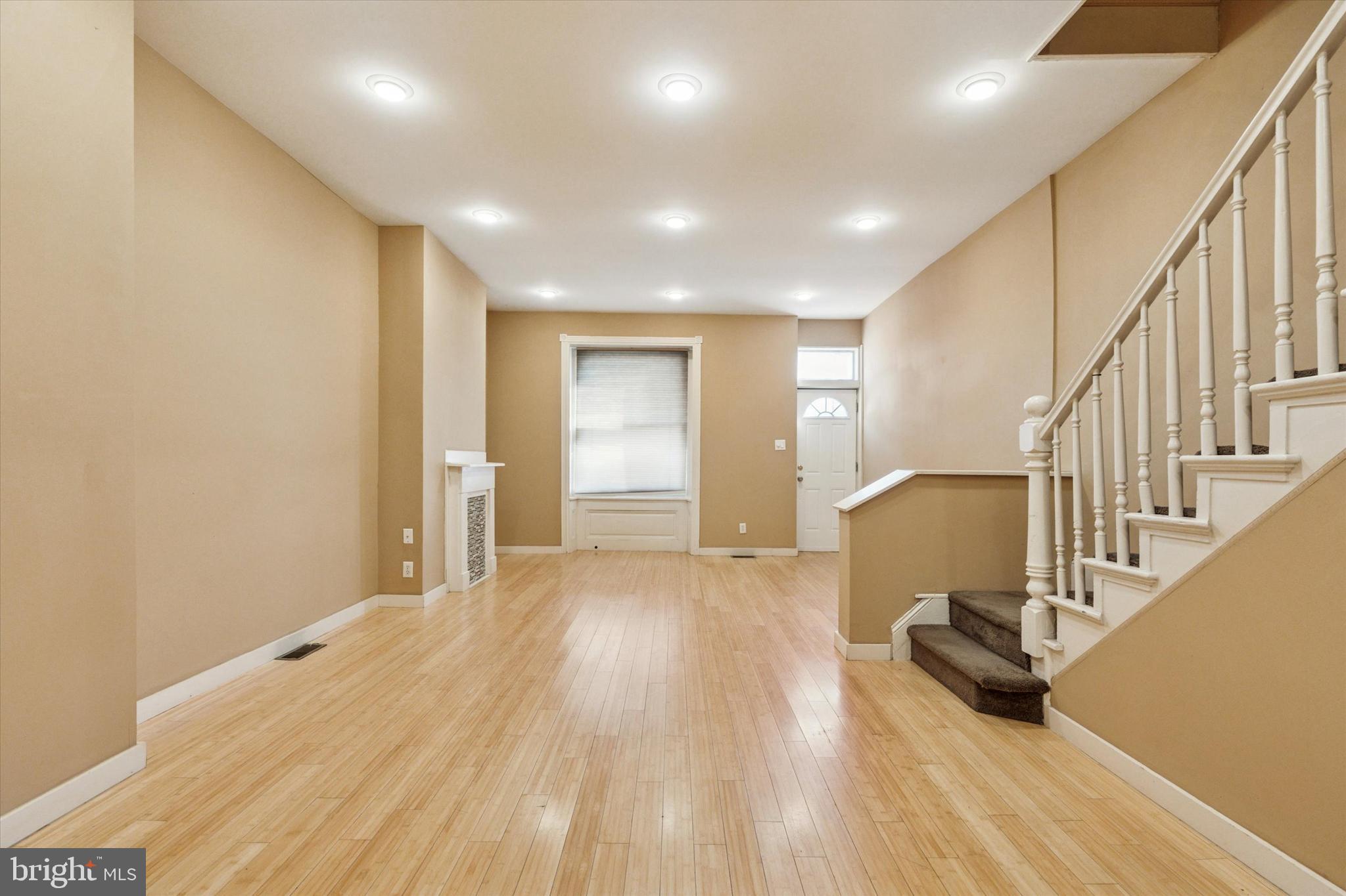 4148 Manayunk Avenue Philadelphia, PA 19128 - Photo 4 of 15 a view of an empty room with wooden floor and stairs