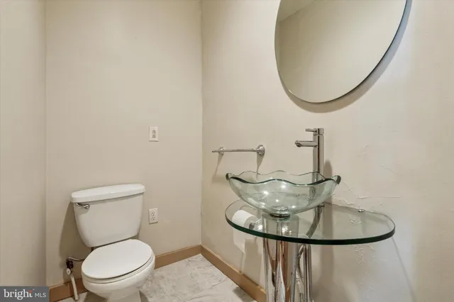 a bathroom with a toilet and a mirror