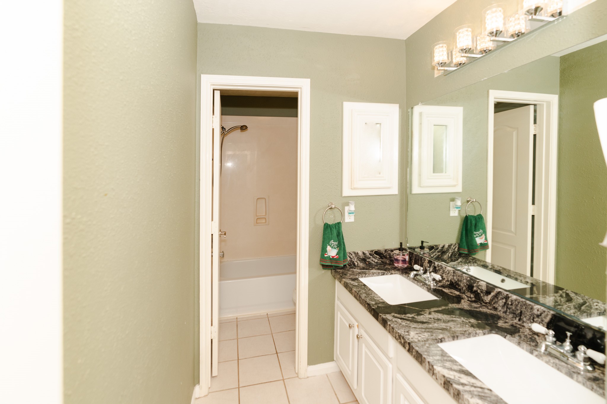 17426 Colony Creek Drive Spring, TX 77379 - Photo 15 of 26 a bathroom with a granite countertop sink and a mirror
