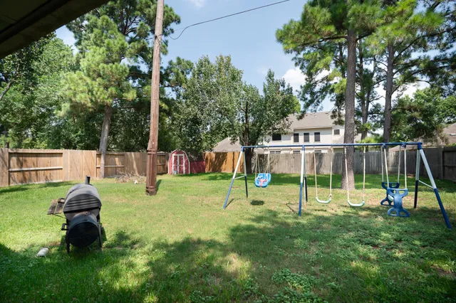 a view of a backyard with swings