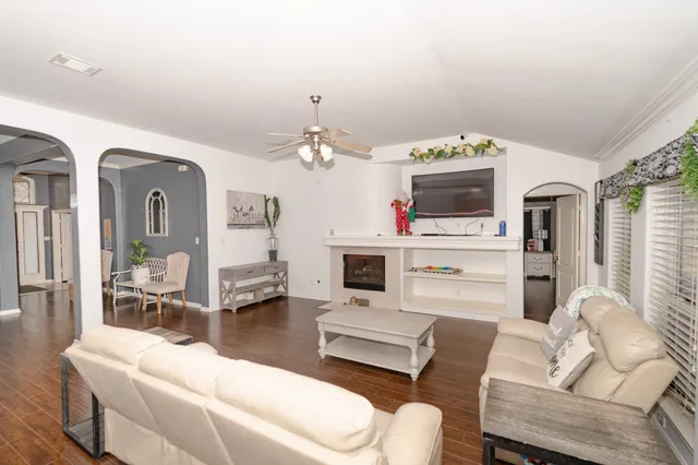 a living room with furniture and a fireplace