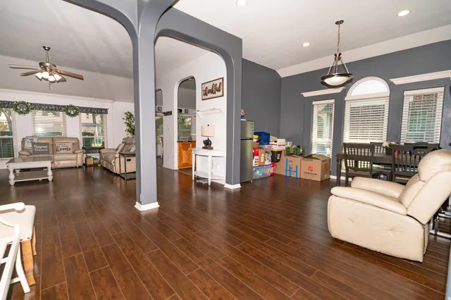 a living room with furniture and wooden floor