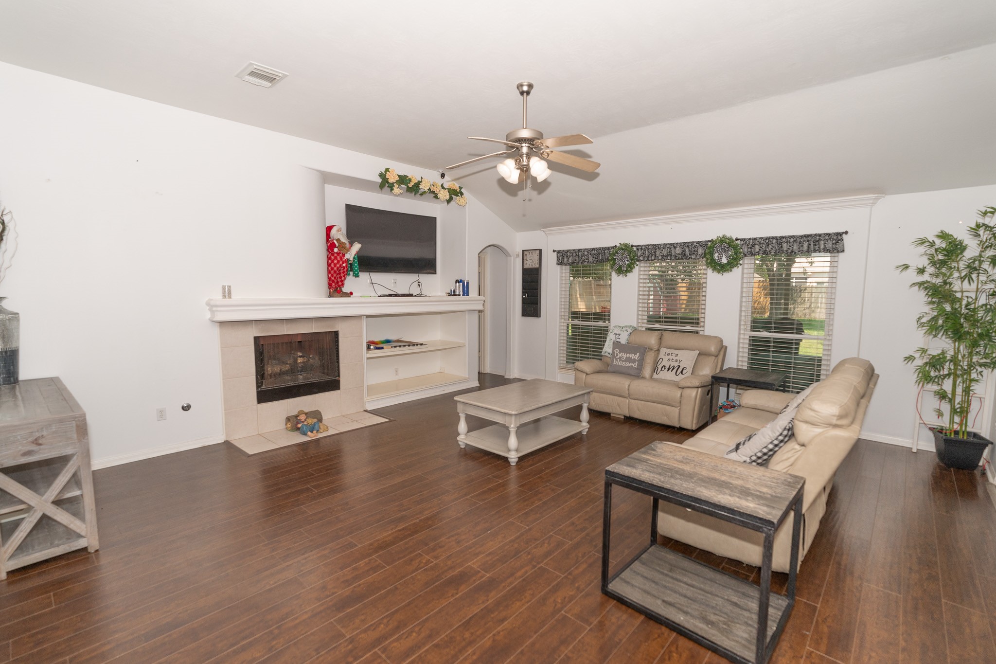 17426 Colony Creek Drive Spring, TX 77379 - Photo 7 of 26 a living room with furniture a fireplace and a flat screen tv