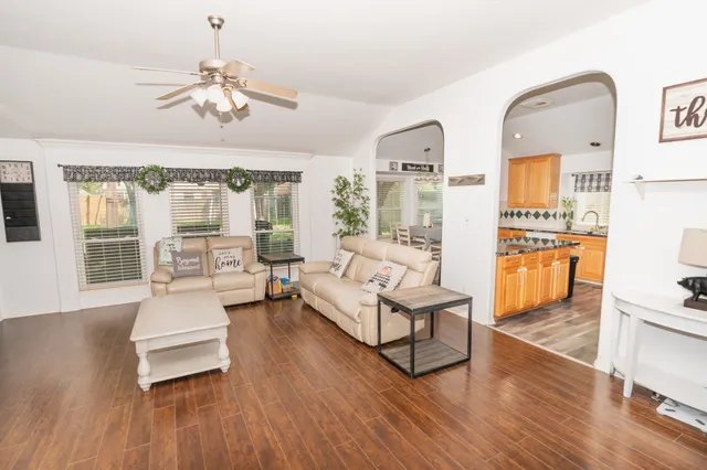 a living room with furniture and a chandelier