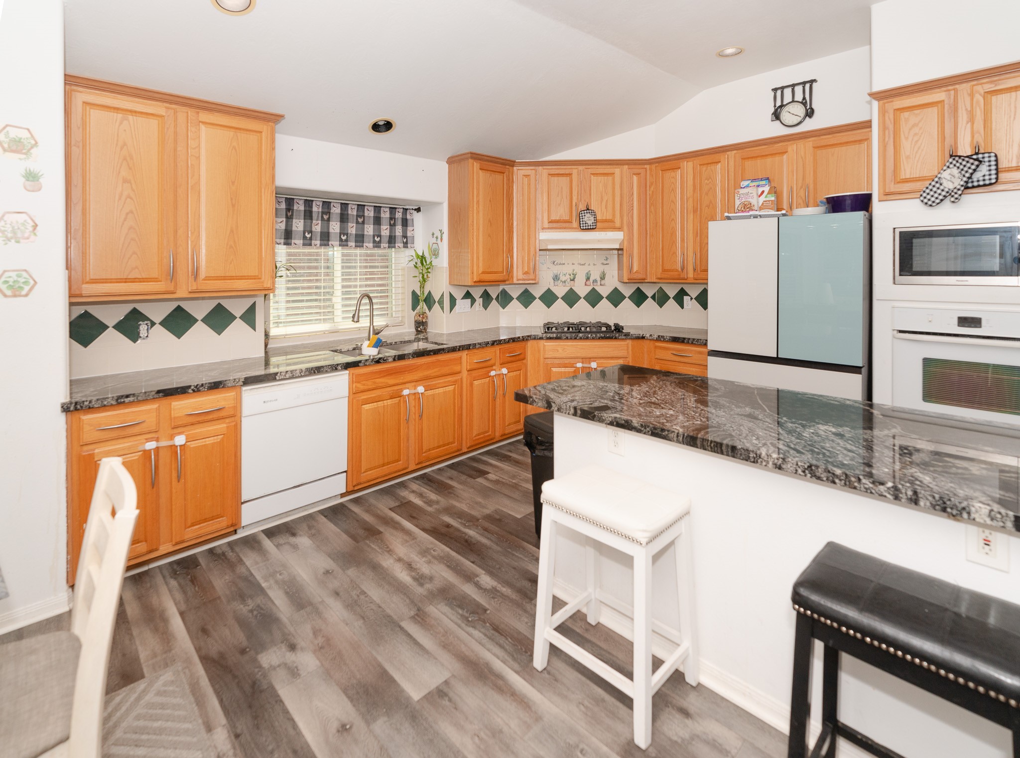 17426 Colony Creek Drive Spring, TX 77379 - Photo 10 of 26 a kitchen with stainless steel appliances granite countertop a sink and a stove