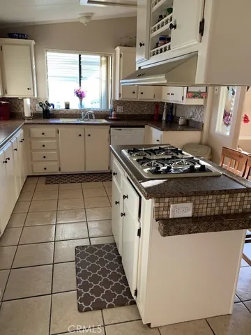a kitchen with a stove a sink and a refrigerator