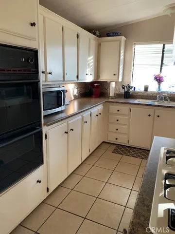a kitchen with stainless steel appliances a stove a sink and a microwave