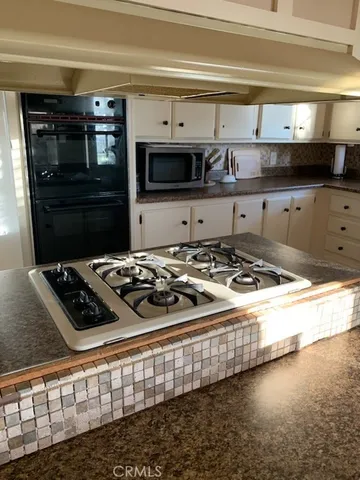 a kitchen with a stove and a refrigerator