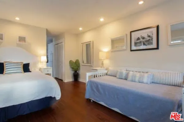 a spacious bedroom with a bed and a couch