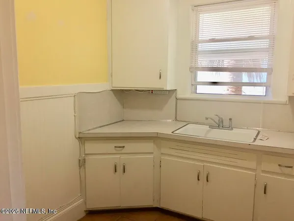 a kitchen with a refrigerator and a sink