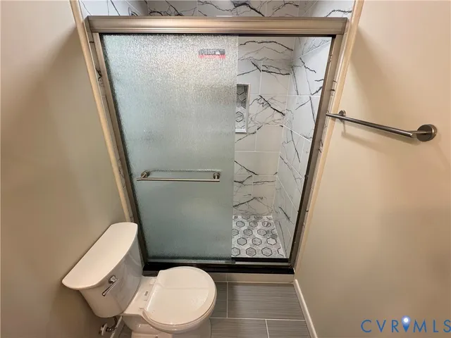 a view of walk in closet with wooden floor and door
