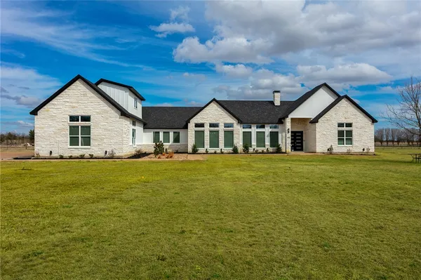 a view of house that has a big yard