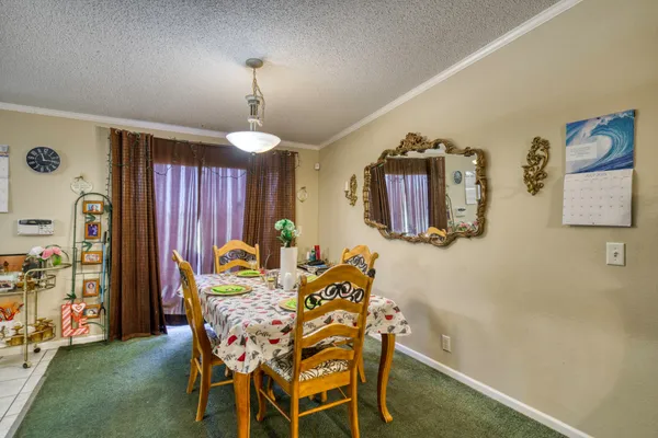 a dining room with furniture and window