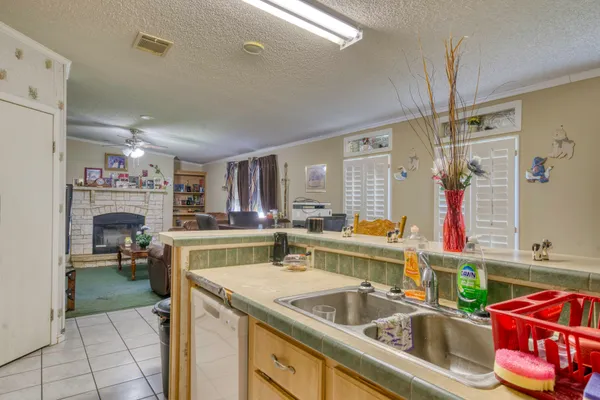 a kitchen that has a lot of cabinets a sink and a stove in it