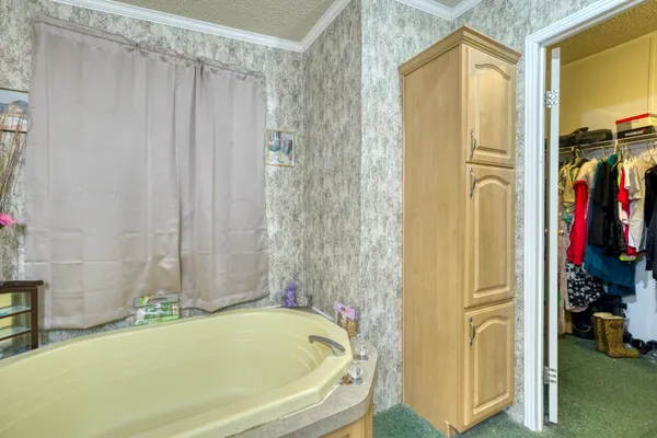 a bathroom with a tub and a shower