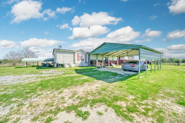 a view of an house with backyard space and balcony