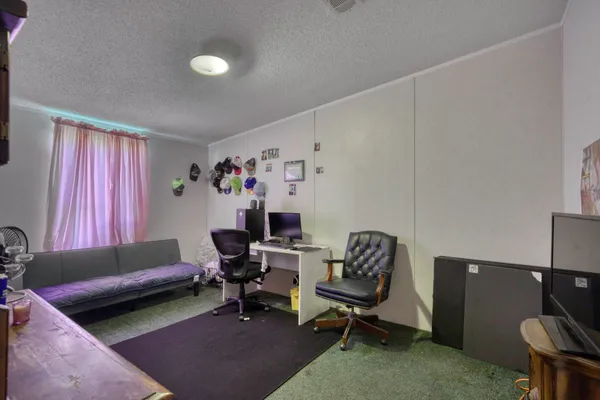 a living room with furniture and a chair