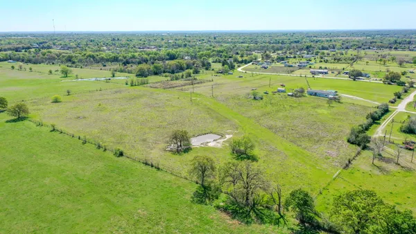 a view of a field with an ocean