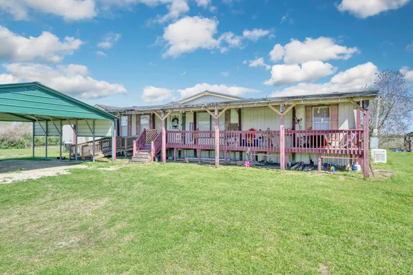 a view of a house with a backyard porch and sitting area