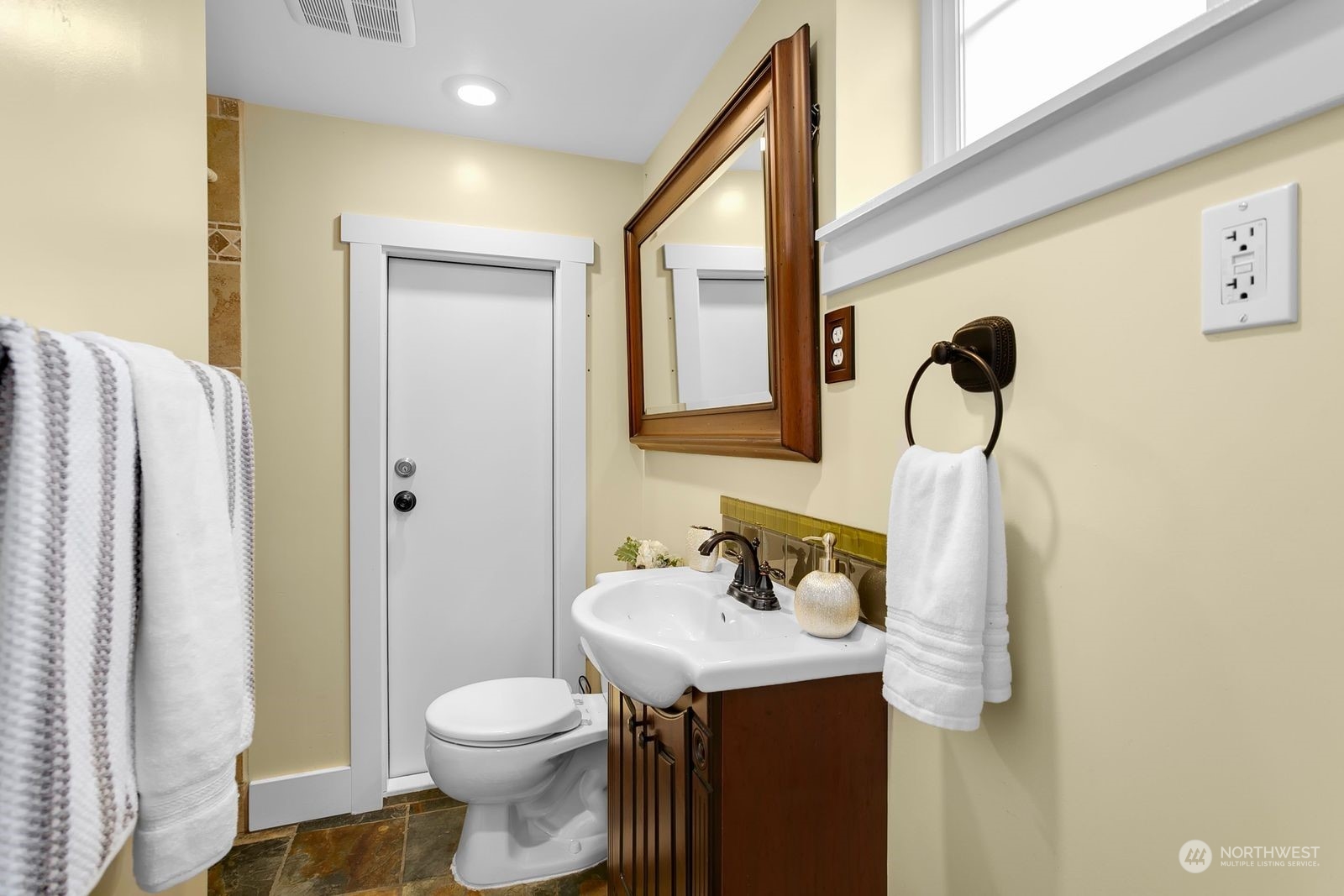 3102 8th Street Everett, WA 98201 - Photo 15 of 22 a bathroom with a sink a toilet and shower curtain